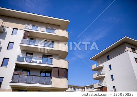 A collection of modern residential buildings set against a clear blue sky, showcasing innovation A collection of modern residential buildings set against a clear blue sky, showcasing innovation 125080822