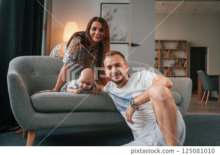 Happy couple with their newborn boy is at home together Happy couple with their newborn boy is at home together 125081010