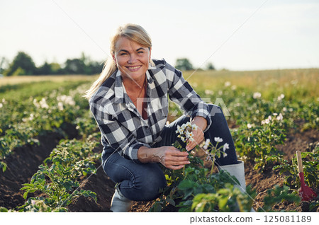 Woman is on the agricultural field at daytime 125081189
