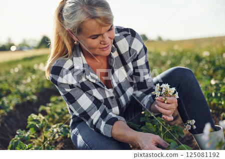 Woman is on the agricultural field at daytime 125081192