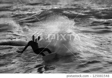Fantastic Surfing Water Splash and SurferJump  He Seemed to be Hanging in the Air (Unrecognizable Person). 125081548