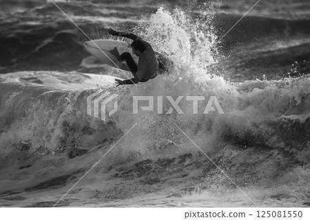 Fantastic Surfing Water Splash and SurferJump He Seemed to be Hanging in the Air (Unrecognizable Person). Fantastic Surfing Water Splash and SurferJump He Seemed to be Hanging in the Air (Unrecognizable Person). 125081550