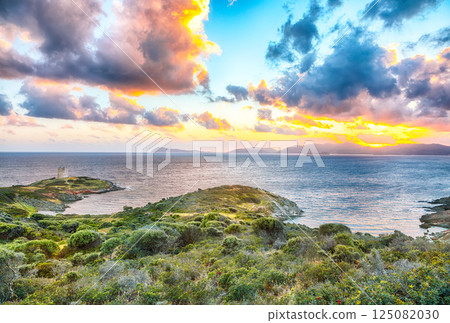 Marvelous sunset view of Piscinni bay with turquoise sea and famous coastal tower of Piscinni. 125082030