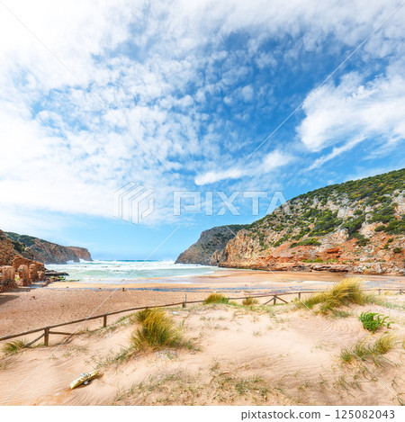 Attractive view of valley Cala Domestica with marvelous sand beach and ruines of old village Attractive view of valley Cala Domestica with marvelous sand beach and ruines of old village 125082043