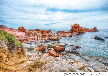 Impressive sunset view of Red Rocks (is Scoglius Arrubius) on Cea beach. Impressive sunset view of Red Rocks (is Scoglius Arrubius) on Cea beach. 125082103
