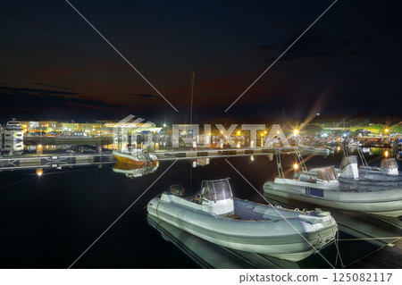 Exciting sunset view on boats in beautiful marina of Villasimius. 125082117