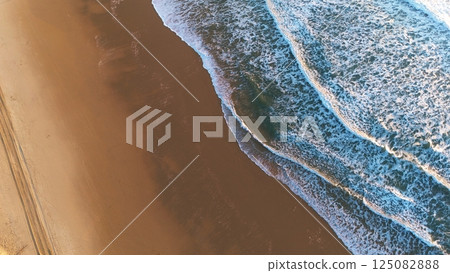 Overhead Drone View of Ocean Waves Meeting Sandy Beach 125082888