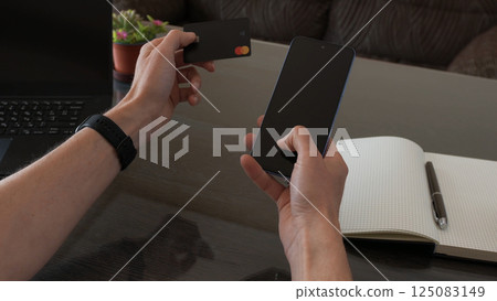 Using Smartphone and Credit Card for Digital Payment on Work Desk Using Smartphone and Credit Card for Digital Payment on Work Desk 125083149