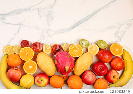 Summer tropical fruits on marble table, source of vitamin C, banner for shop, healthy vegan products for healthy lifestyle, detox diet and weight loss concept, shop advertisement. Summer tropical fruits on marble table, source of vitamin C, banner for shop, healthy vegan products for healthy lifestyle, detox diet and weight loss concept, shop advertisement. 125083249