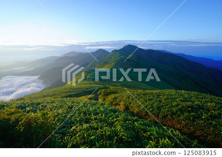 The ridgeline bathed in the morning sun from Mount Monnai in the Iide mountain range The ridgeline bathed in the morning sun from Mount Monnai in the Iide mountain range 125083915
