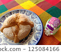 "Day of the Dead bread" and sugar skeleton pastries served on a Talavera plate 125084166