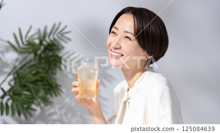 Woman drinking highball Woman drinking highball 125084639