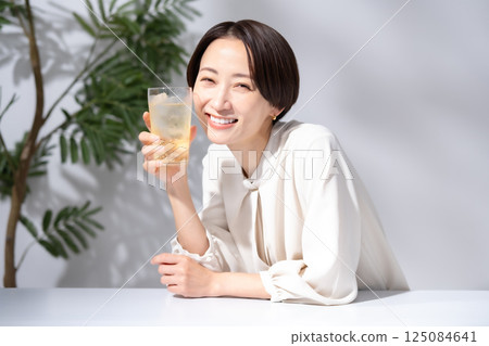 Woman drinking highball Woman drinking highball 125084641