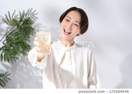 Woman drinking highball Woman drinking highball 125084646