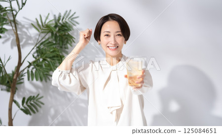 Woman drinking highball Woman drinking highball 125084651