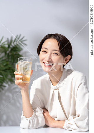 Woman drinking highball Woman drinking highball 125084663