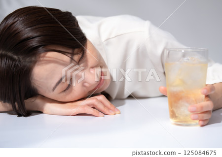 Woman drinking highball Woman drinking highball 125084675