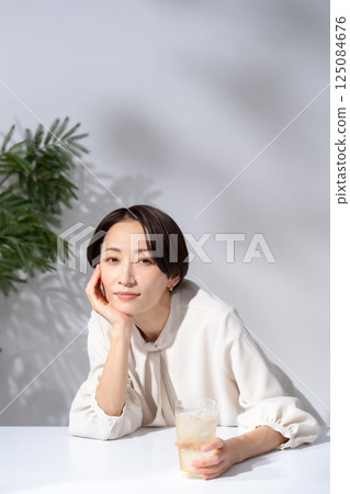 Woman drinking highball Woman drinking highball 125084676