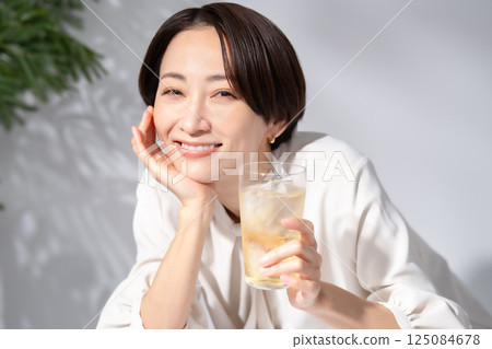 Woman drinking highball Woman drinking highball 125084678