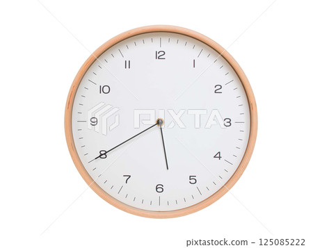 Minimal wall clock with light wood frame and white face displaying 05:40 or 17:40. Perfect for clean, modern concepts about time and scheduling. 125085222