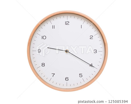 Minimal wall clock with light wood frame and white face displaying 09:20 or 21:20. Perfect for clean, modern concepts about time and scheduling. 125085394