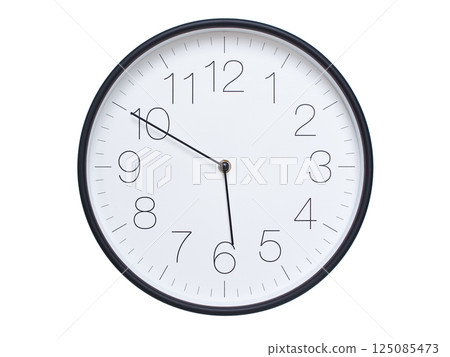 Simple wall clock with black frame and white face displaying 05:50 or 17:50. Ideal for time, schedule, and punctuality themes. 125085473