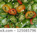 A layer of sliced Mexican green chili peppers (Serrano chiles) 125085796