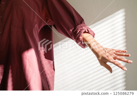 Cropped Woman in Maroon Shirt Reaching Out. Creative Mood for Blog, Fashion or Magazine. 125086279