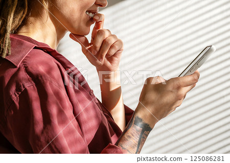 Woman Holds Smartphone Making Decision. Using Cellphone Device for Social Media or Networking. 125086281