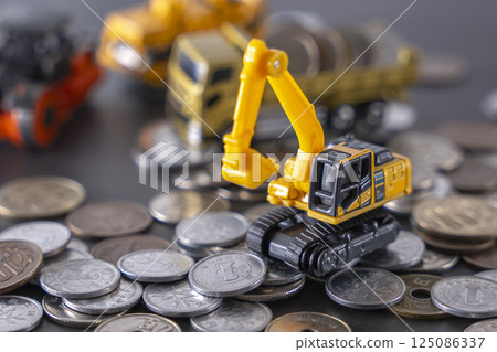 Construction vehicles among coins Savings Investment Construction vehicles among coins Savings Investment 125086337