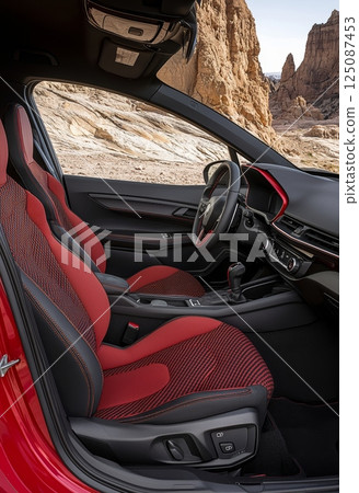 Stylish and Vibrant Interior of a Sporty Hatchback Car in Scenic Landscape Stylish and Vibrant Interior of a Sporty Hatchback Car in Scenic Landscape 125087453