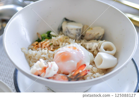 rice with soft boiled egg and seafood, seafood and rice rice with soft boiled egg and seafood, seafood and rice 125088127