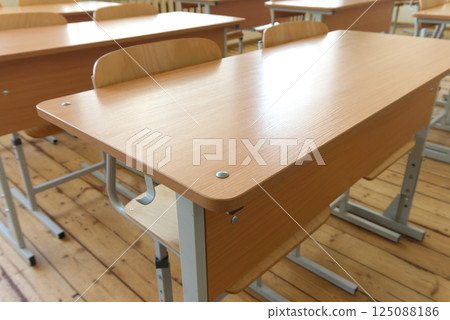 Classroom Desks Arranged in Rows Under Bright Natural Light With Metal Legs Classroom Desks Arranged in Rows Under Bright Natural Light With Metal Legs 125088186