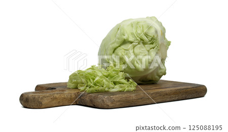Fresh Green Cabbage on Wooden Cutting Board with Sliced Leaves 125088195