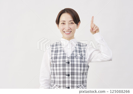 Female office worker pointing up white background Female office worker pointing up white background 125088266