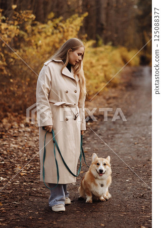 Woman with Corgi in Autumn Park Woman with Corgi in Autumn Park 125088377