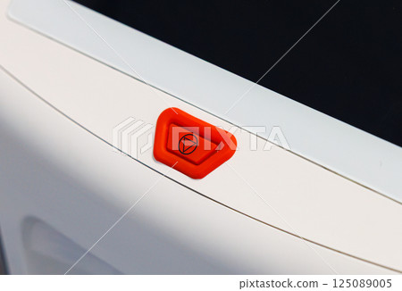 Medical equipment control panel showcasing a vibrant orange activation button for efficient operation 125089005