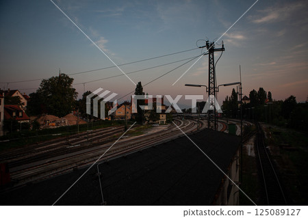 Evening tranquility along the German railway tracks with buildings in the backdrop 125089127