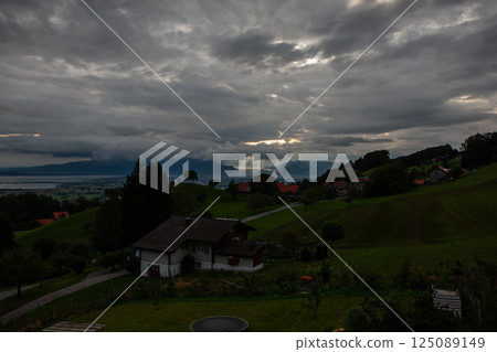 Majestic mountains embrace the serene Bodensee landscape under a moody sky in Switzerland 125089149