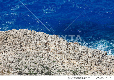 Crystal-clear waves crashing against rocky shores of Ayia Napa reveal natural beauty of Cyprus coastline Crystal-clear waves crashing against rocky shores of Ayia Napa reveal natural beauty of Cyprus coastline 125089326