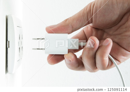 Hand of Electrical Appliances He was pulling the plug. Out of the plug. In his office during work hours. Energy Saving Concepts and Technologies 125091114