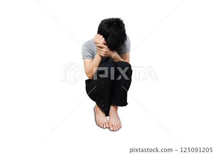 A man sitting in the corner of the room strained unhappy.black and white picture 125091205