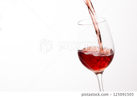 Pour the red wine into the glass 125091505