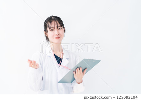 A female doctor in a white coat holding a file to ask a question, white background A female doctor in a white coat holding a file to ask a question, white background 125092194