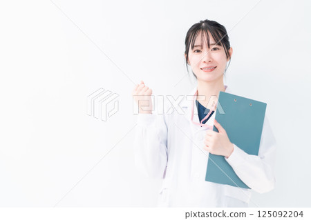 Female doctor posing with fist on white background Female doctor posing with fist on white background 125092204