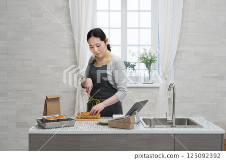 Woman making pound cake in the kitchen Woman making pound cake in the kitchen 125092392