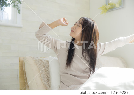 Woman getting up in bed Woman getting up in bed 125092853
