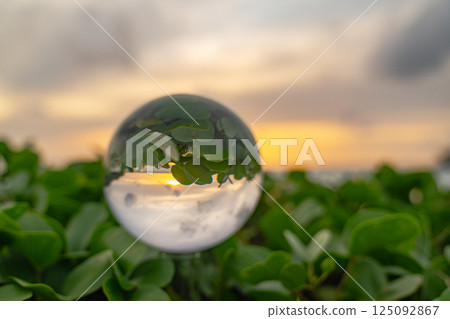 view of sweet sunset on the beach inside crystal ball view of sweet sunset on the beach inside crystal ball 125092867