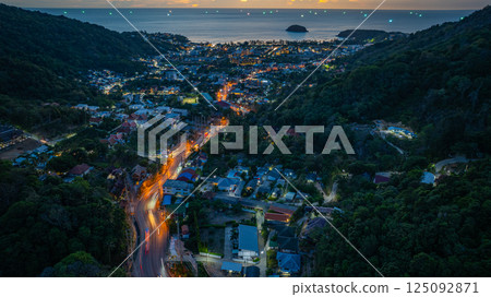 Vibrant Sunset Over Coastal Town and Hills Vibrant Sunset Over Coastal Town and Hills 125092871