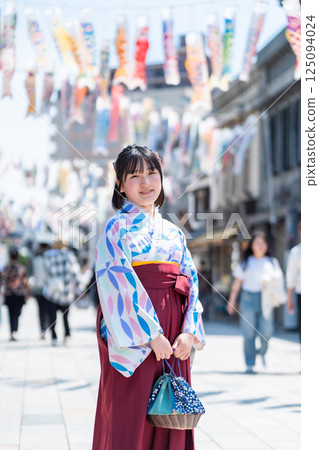 A girl wearing a hakama on Kawagoe Taisho Roman Street 125094024
